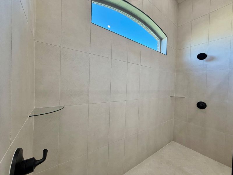 Full bathroom featuring tiled shower