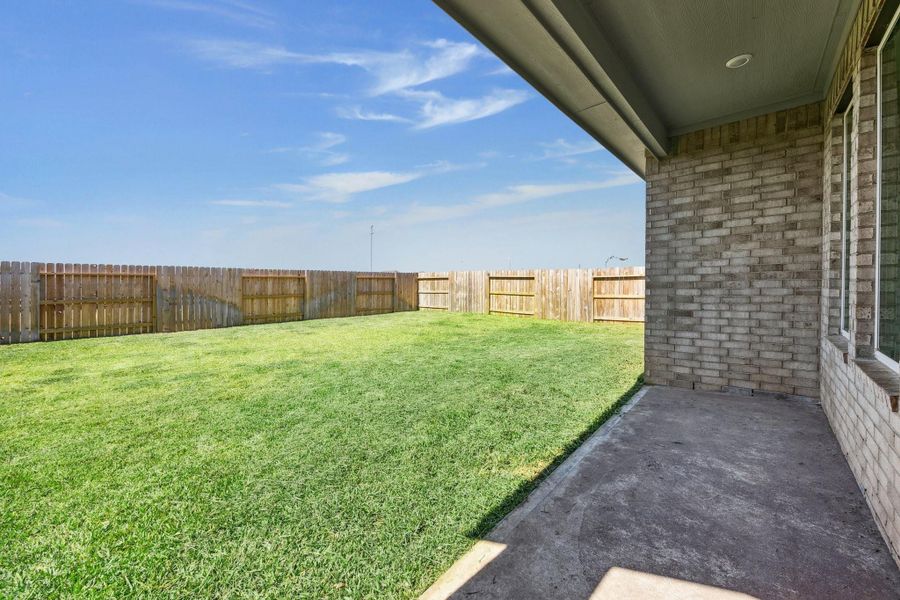 Spacious out door backyard with covered outdoor patio.