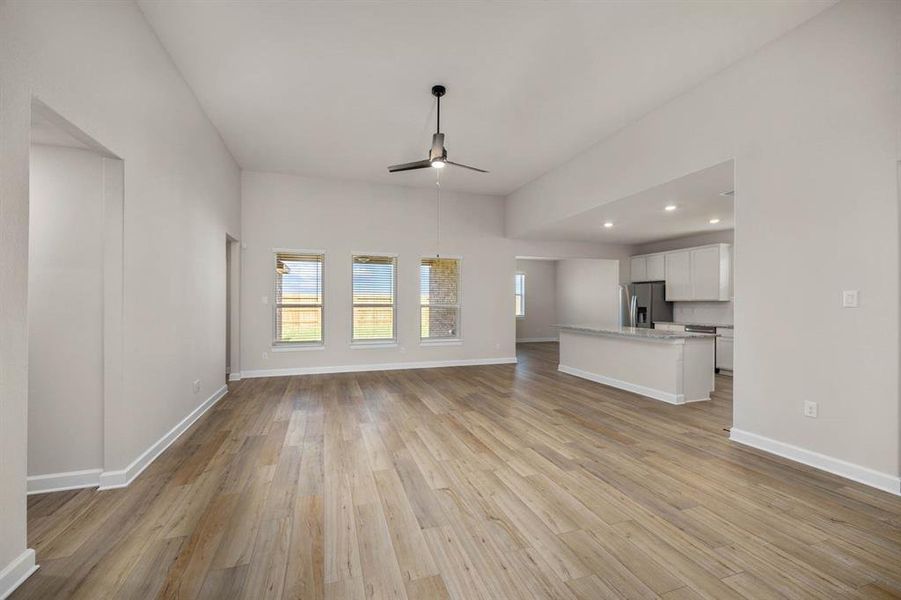 Experience seamless living in this bright and airy living room with an open floor plan that flows effortlessly into the kitchen while offering picturesque views of the backyard. The perfect blend of comfort and style for entertaining and relaxation.