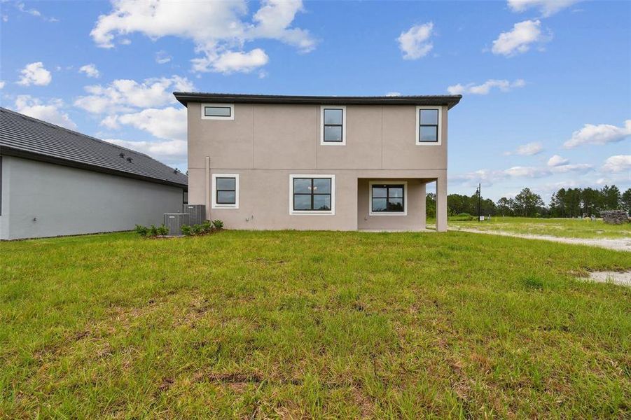 Front exterior of a new home in Tamarack at Two Rivers, Zephyrhills, FL, highlighting curb appeal (Image 13). Front exterior of a new home in Tamarack at Two Rivers, Zephyrhills, FL, highlighting curb appeal (Image 13).