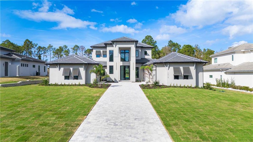 Front exterior of a new home in , Montverde, FL, highlighting curb appeal (Image 28). Front exterior of a new home in , Montverde, FL, highlighting curb appeal (Image 28).