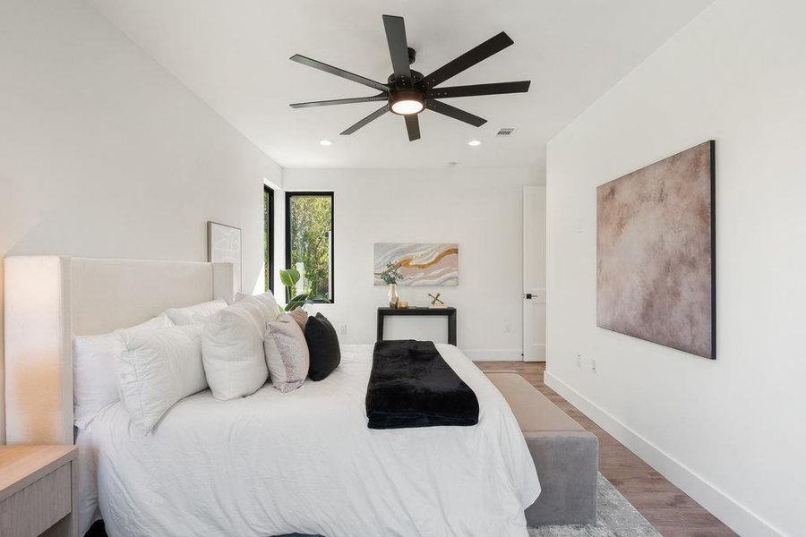 Bedroom featuring wood finished floors, ceiling fan, and recessed lighting