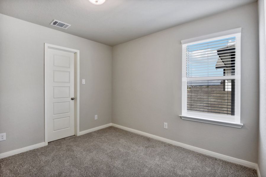 Guest bedroom in the Medina floorplan at a Meritage Homes community.