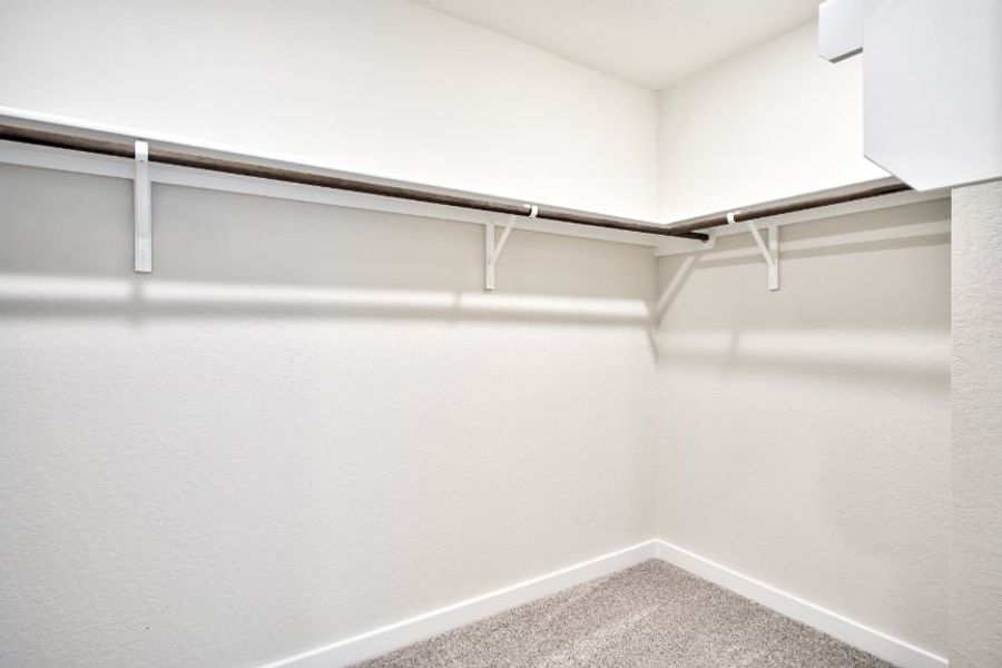 A white wall with a metal railing.