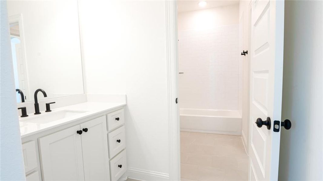 Bathroom with vanity and washtub / shower combination Bathroom with vanity and washtub / shower combination