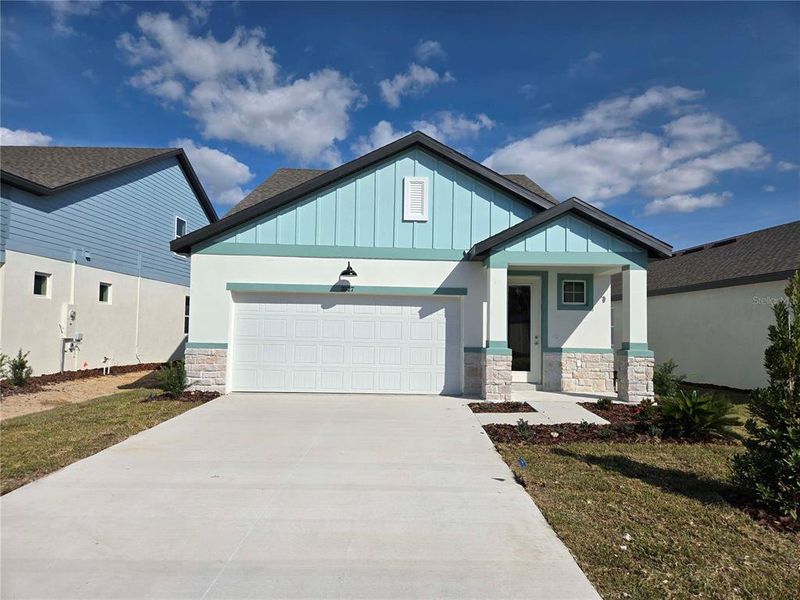 Front exterior of a new home in Arbor Meadows, Spring Hill, FL, highlighting curb appeal (Image 1).