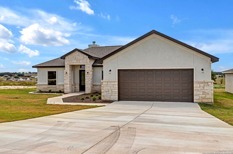Front exterior of a new home in , La Vernia, TX, highlighting curb appeal (Image 2). Front exterior of a new home in , La Vernia, TX, highlighting curb appeal (Image 2).