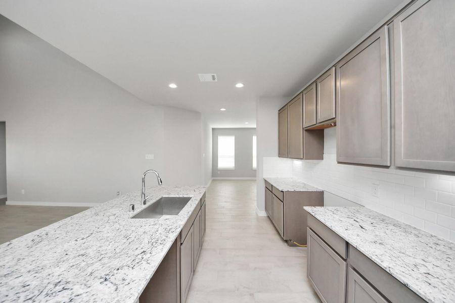 This generously spacious kitchen is a dream realized! Sample photo of completed home with similar floor plan. Actual colors and selections may vary.