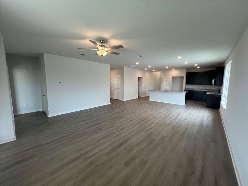 An open floorplan seamlessly connects living and kitchen spaces, ideal for modern entertaining.