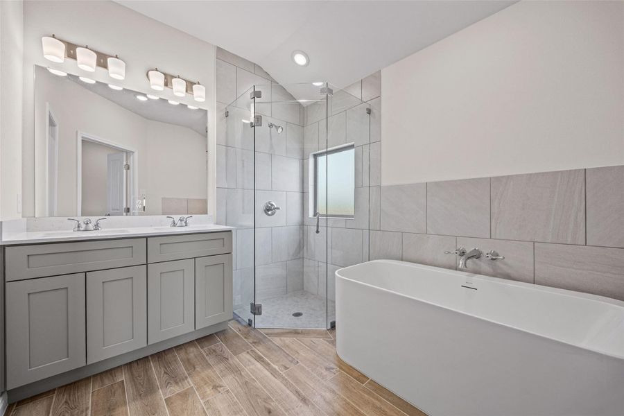 Clean lines define this modern bathroom with a freestanding tub and a glass-enclosed shower. Clean lines define this modern bathroom with a freestanding tub and a glass-enclosed shower.