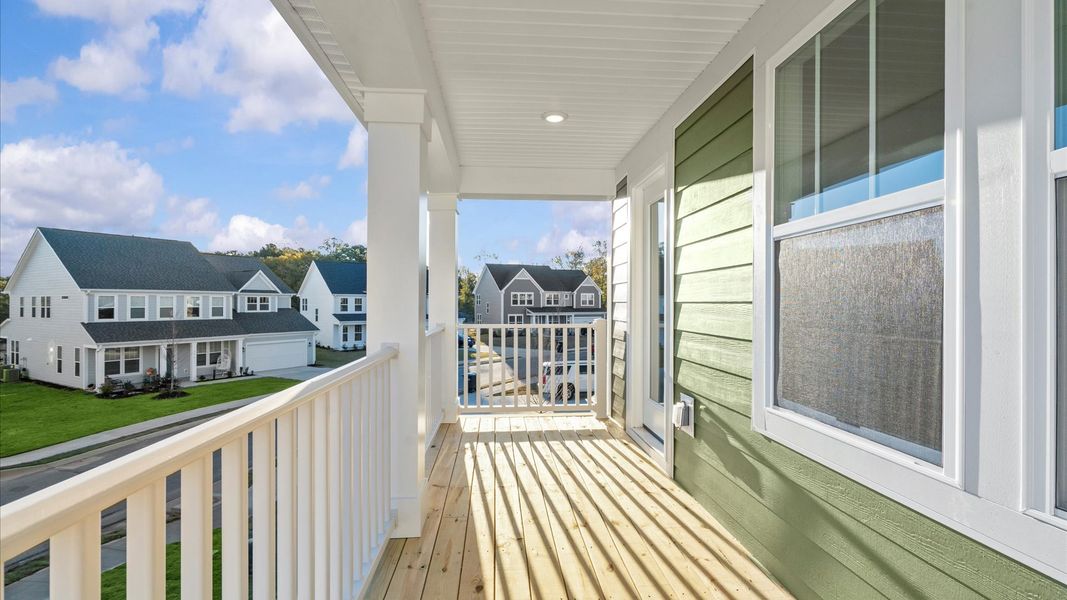 Second story balcony creates a seamless extension of this home’s elegant design
