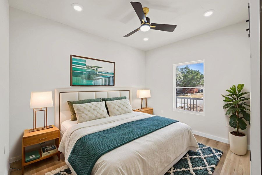Bedroom featuring wood finished floors, ceiling fan, and recessed lighting Bedroom featuring wood finished floors, ceiling fan, and recessed lighting