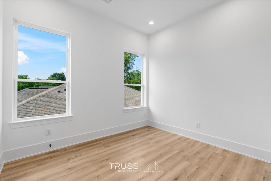 Generous windows invite natural light from multiple angles, giving this secondary bedroom a bright, open feel. This spacious secondary is ready to adapt as a guest suite, office, or creative retreat.