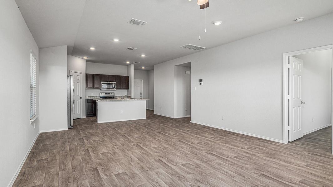 Kitchen with dark wood finish cabinets, a center island, open floor plan, dark wood finished floors, and ceiling fan Kitchen with dark wood finish cabinets, a center island, open floor plan, dark wood finished floors, and ceiling fan