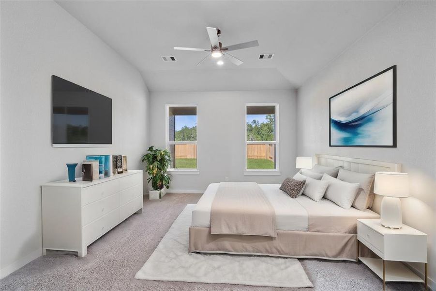 Come and unwind after a long day in this magnificent primary suite! This spacious room features plush carpet, warm paint, sitting area, ceiling fan, high ceilings, and large windows with privacy blinds!