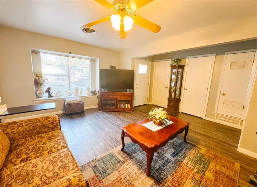 Living room with wood finished floors and ceiling fan