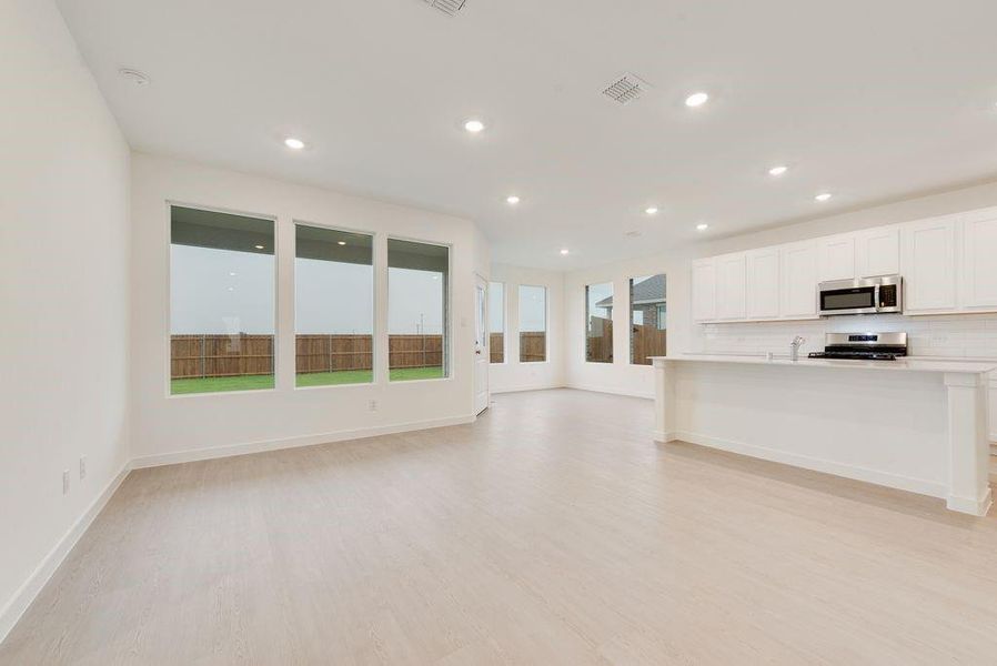 Unfurnished living room with light wood finished floors and recessed lighting Unfurnished living room with light wood finished floors and recessed lighting