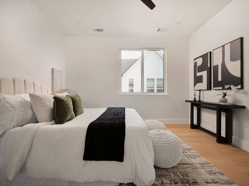 Bedroom featuring light wood-style flooring and a ceiling fan Bedroom featuring light wood-style flooring and a ceiling fan