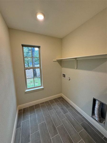 Washroom featuring hookup for a washing machine, hookup for a gas dryer, and dark hardwood / wood-style flooring