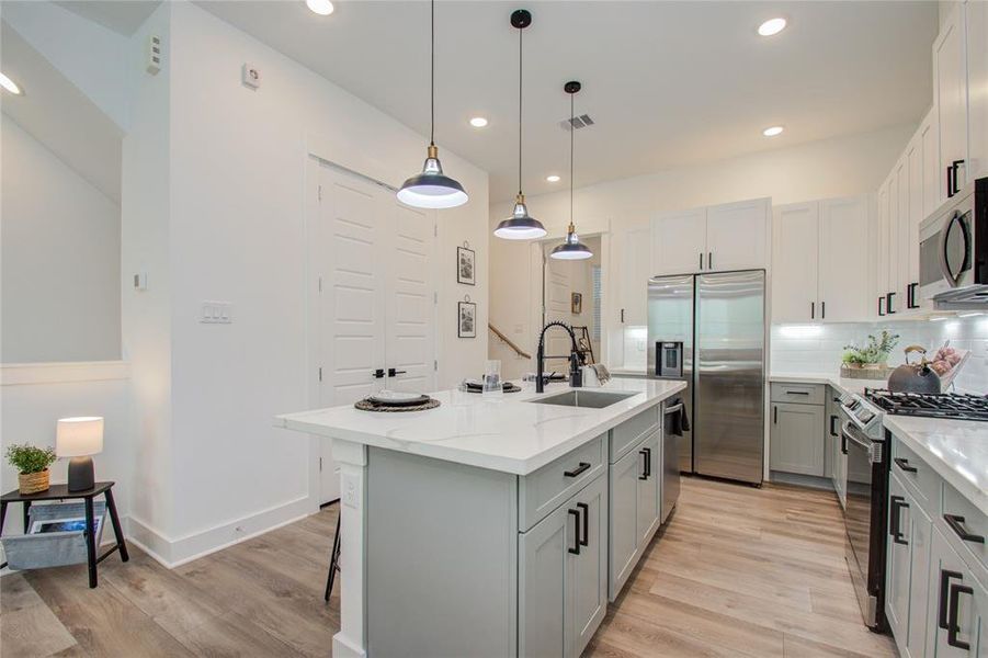 This attractive Kitchen is full of beautiful details. Quartz Countertops, Stainless Sink, Stainless Steel Appliances, Recessed Lighting and pendant lights, Undercabinet Lighting, Elegant Cabinetry with Soft Close Drawers and Doors. UNDER CONSTRUCTION!!  Photos from another community's model home FINISHES & COLORS MAY VARY! Ceiling fans are not included!