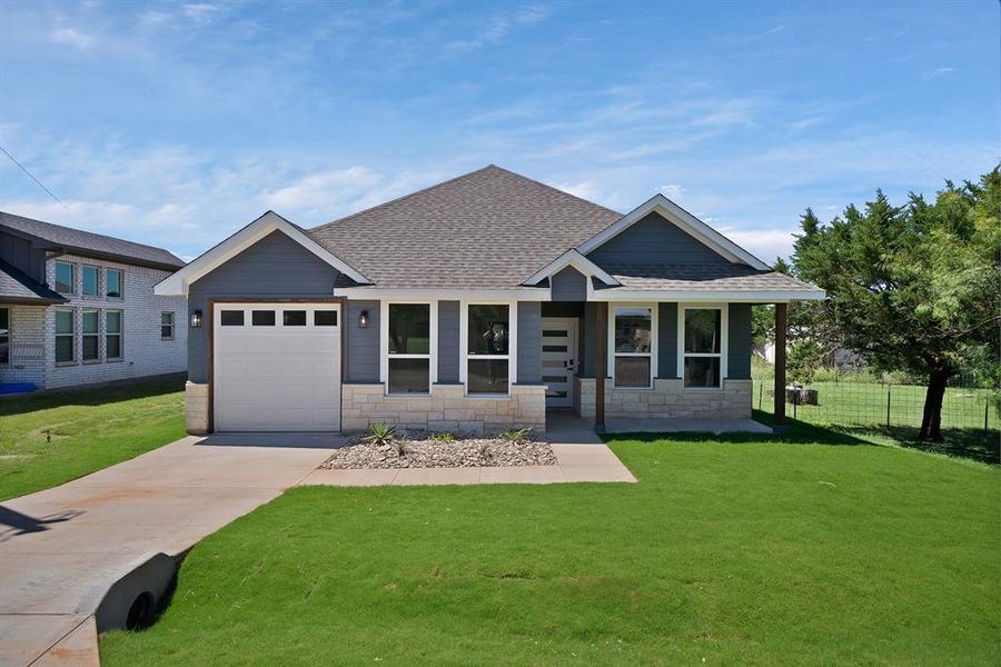 Front exterior of a new home in , Granbury, TX, highlighting curb appeal (Image 13).