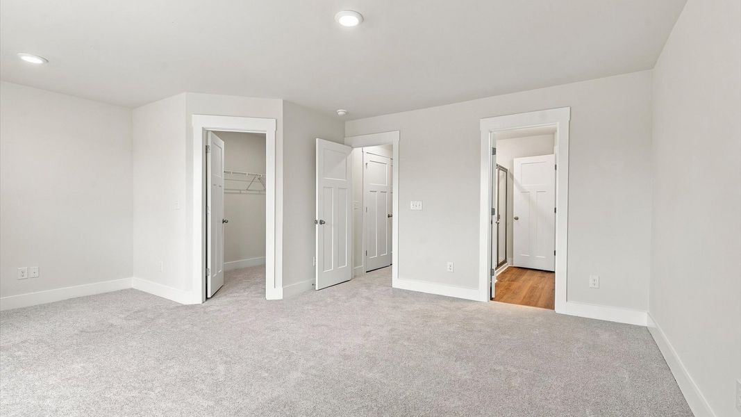 Eye-catching details and elegant finishes in the vibrant primary suite of this select home at Ransdell Pointe Eye-catching details and elegant finishes in the vibrant primary suite of this select home at Ransdell Pointe