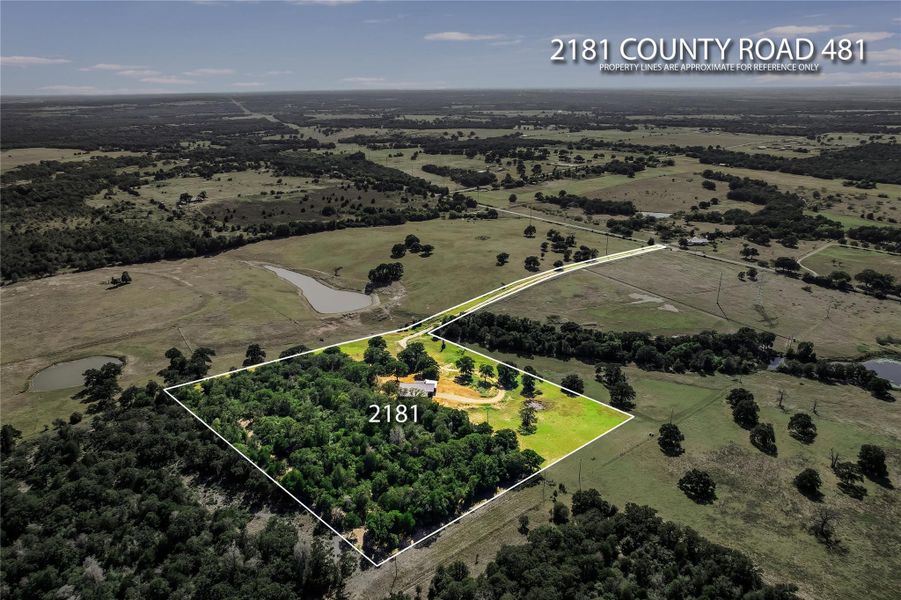 Overview of rural landscape featuring property parcel outlined and a tree filled landscape