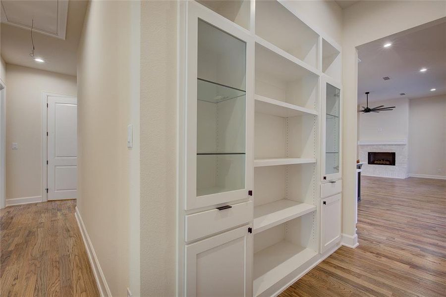 Behind the kitchen is a built in display shelving unit.