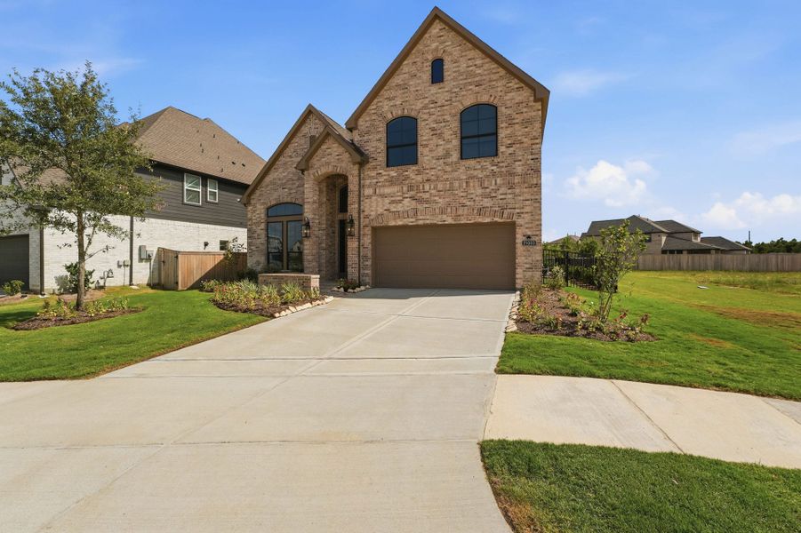 Front exterior of a new home in Bridgeland 50′, Cypress, TX, highlighting curb appeal (Image 18).