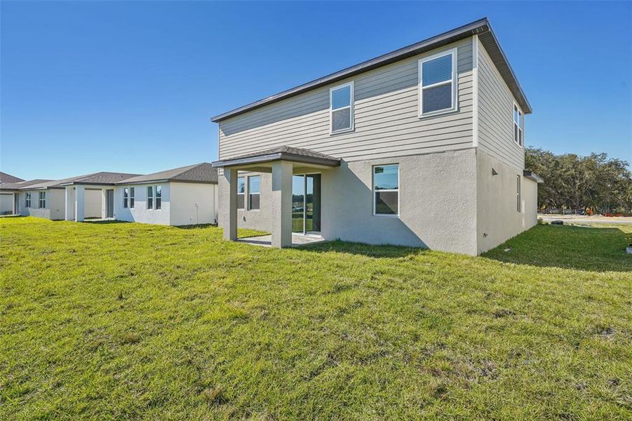 Exterior details and patio area of a home in The Reserve at Hammock Oaks - Signature Series, Lady Lake (Image 4).