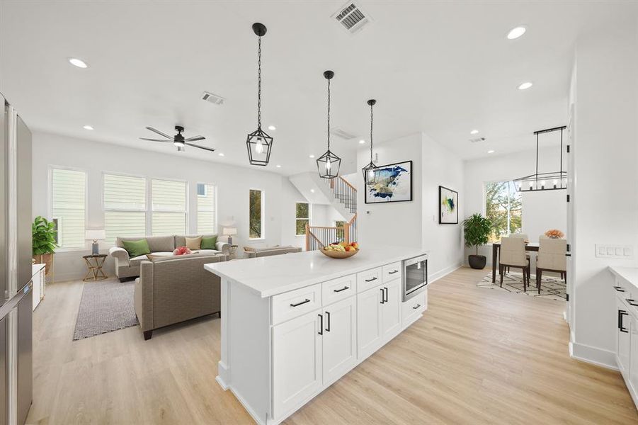 Virtually Staged: This photo highlights the open space - also featuring the flex space adjacant the kitchen. A great space for a dining room, home office, or bonus living space. Photos are from a similar unit in the development.