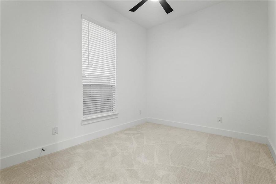 Spare room with light colored carpet and a ceiling fan Spare room with light colored carpet and a ceiling fan