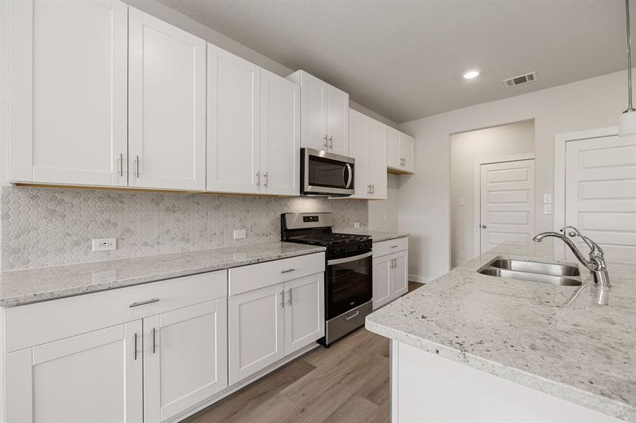 Any chef's dream, this stunning kitchen is perfect for everyday life as well as entertaining family and friends! Extra large kitchen island is perfect for conversation or that much needed space to lay out your party spread for everyone to enjoy! Large windows provide lovely views of your backyard and plenty of natural lighting throughout the day.