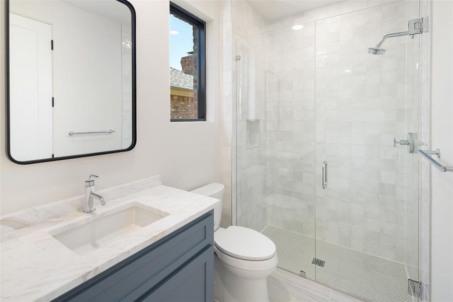 Bathroom with vanity, toilet, and walk in shower