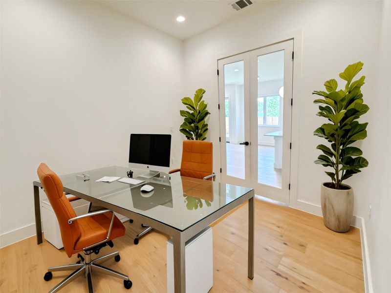 Office space with light wood finished floors, french doors, and recessed lighting Office space with light wood finished floors, french doors, and recessed lighting