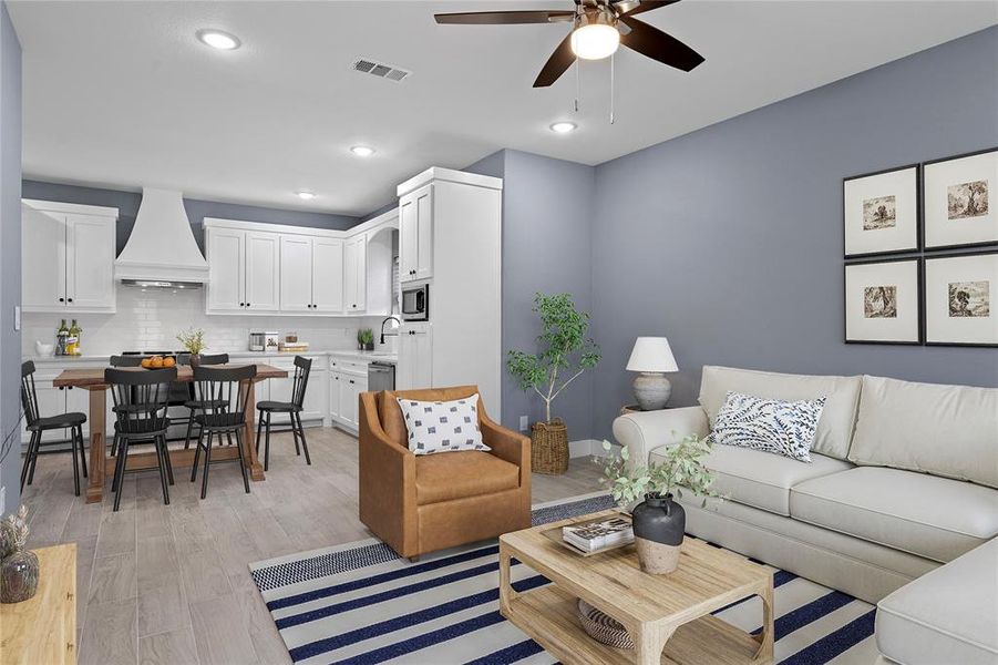 Living area featuring light wood-type flooring, recessed lighting, and a ceiling fan Living area featuring light wood-type flooring, recessed lighting, and a ceiling fan