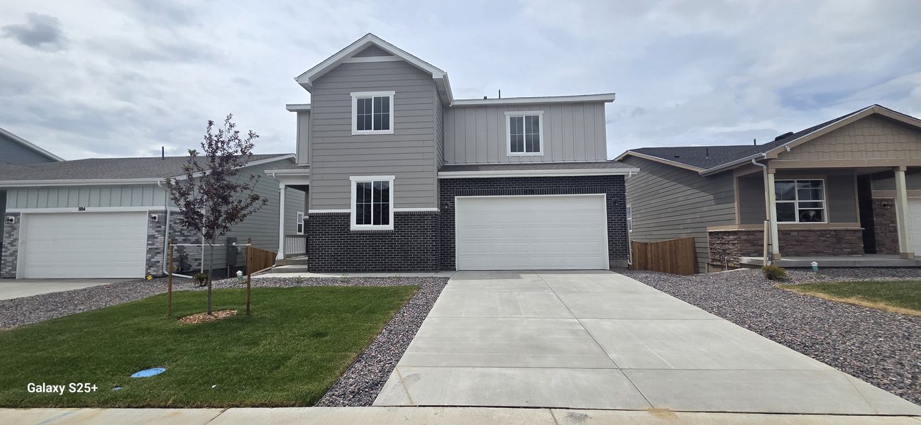 Front exterior of a new home in The Overlook at Johnstown Farms, Johnstown, CO, highlighting curb appeal (Image 1). Front exterior of a new home in The Overlook at Johnstown Farms, Johnstown, CO, highlighting curb appeal (Image 1).