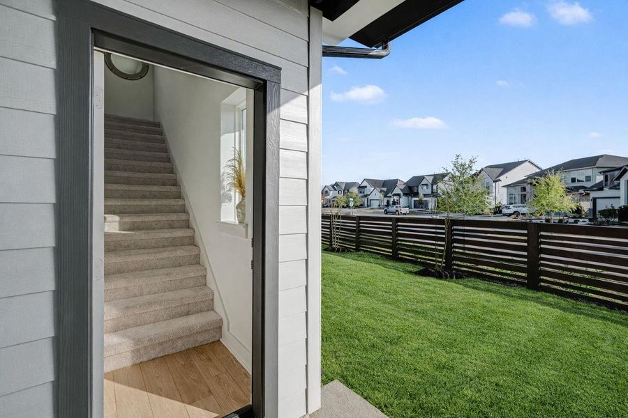 Private exterior entry to the garage apartment featuring its own staircase, offering ideal separation and flexibility for guests or extended family.