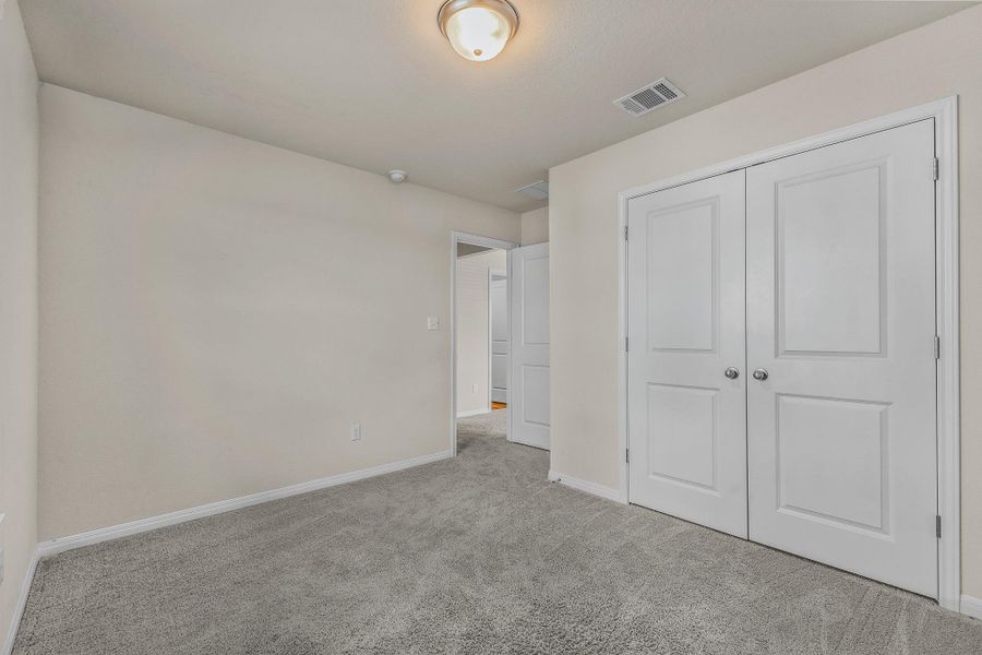 Unfurnished bedroom with carpet flooring and a closet Unfurnished bedroom with carpet flooring and a closet