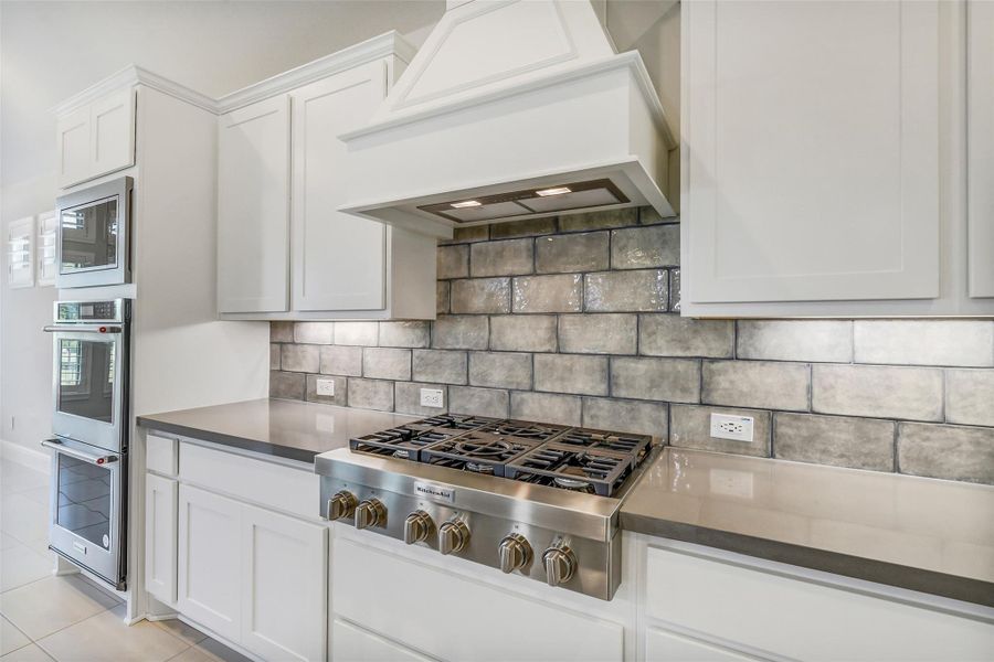 The six burner Kitchenaid cook top can handle big and small meals. The tile flooring and backsplash makes for easy clean up. The six burner Kitchenaid cook top can handle big and small meals. The tile flooring and backsplash makes for easy clean up.