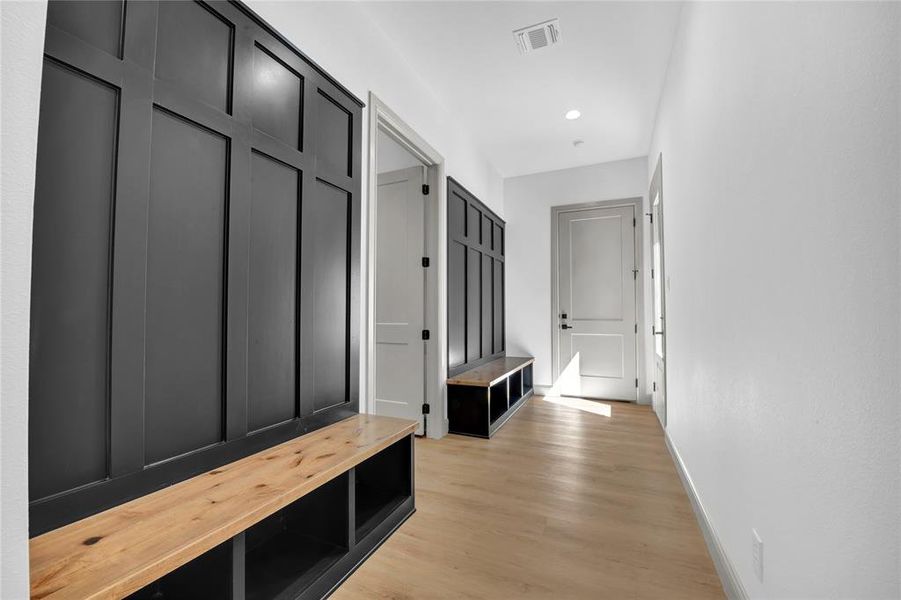 Mudroom with light hardwood / wood-style flooring