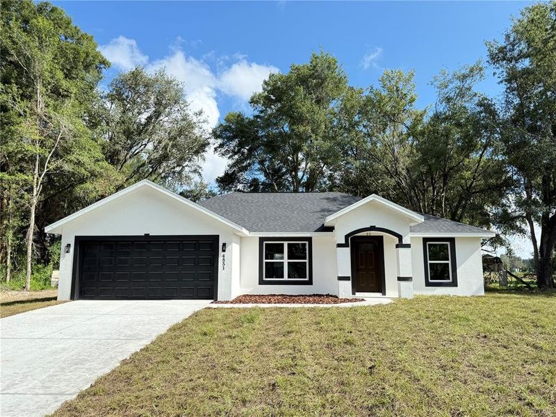 Front exterior of a new home in , Summerfield, FL, highlighting curb appeal (Image 1). Front exterior of a new home in , Summerfield, FL, highlighting curb appeal (Image 1).