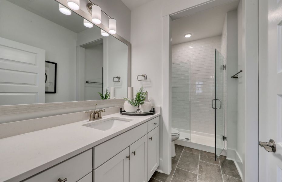 The secondary bathroom features a luxurious soaking tub.