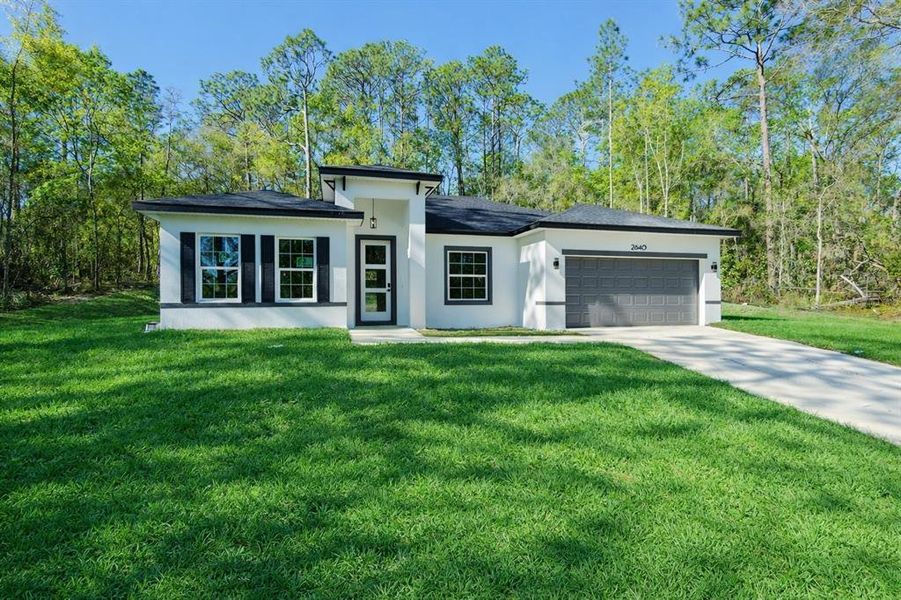 Front exterior of a new home in , Citrus Springs, FL, highlighting curb appeal (Image 1). Front exterior of a new home in , Citrus Springs, FL, highlighting curb appeal (Image 1).