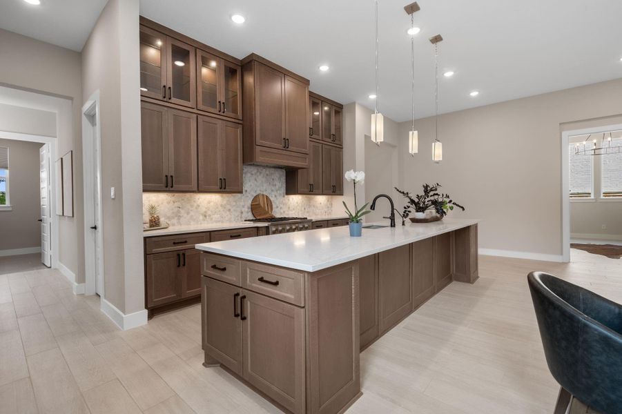 The rich cabinetry is complemented by sleek, quartz countertops, creating a clean and modern look. The rich cabinetry is complemented by sleek, quartz countertops, creating a clean and modern look.