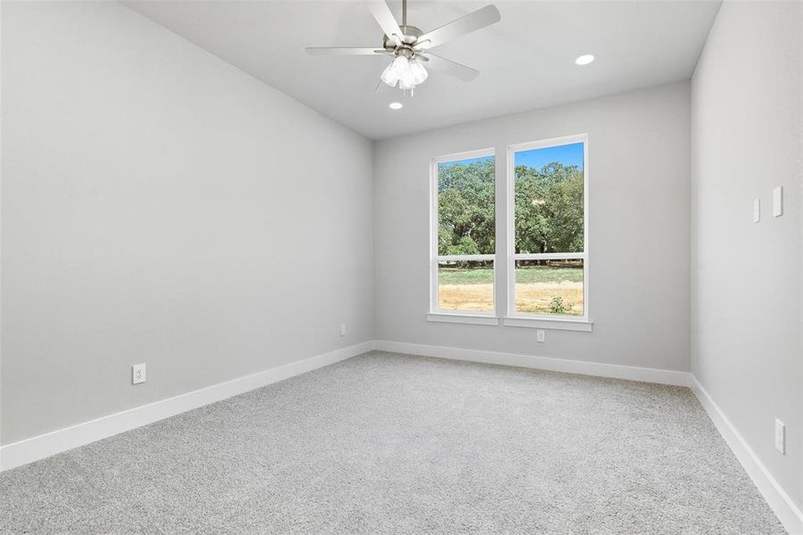Spare room with light colored carpet, ceiling fan, and recessed lighting