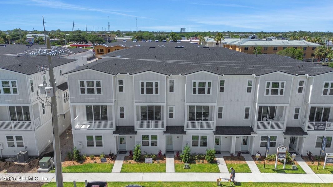 Front exterior of a new home in North Beach Townhomes, Jacksonville Beach, FL, highlighting curb appeal (Image 2).