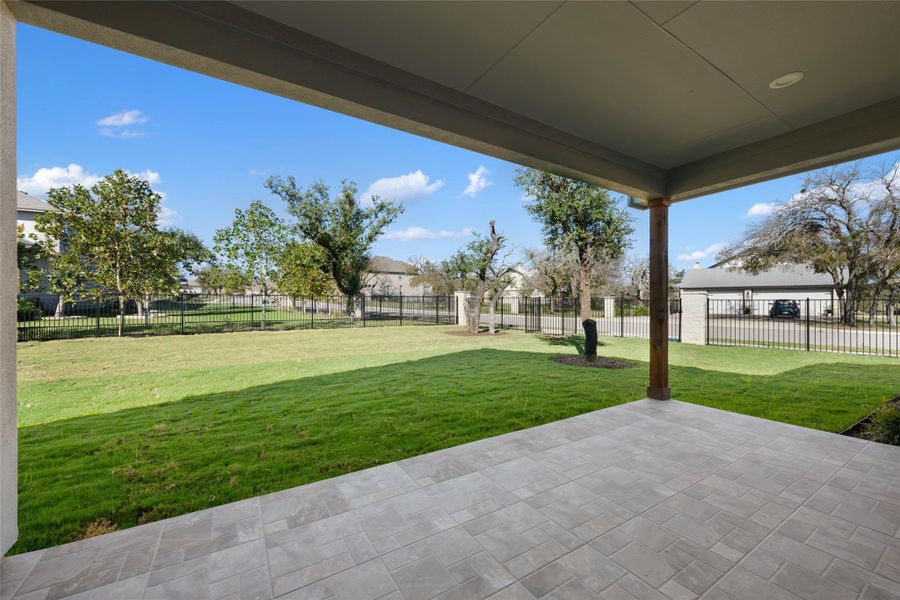 Fenced backyard with a patio area