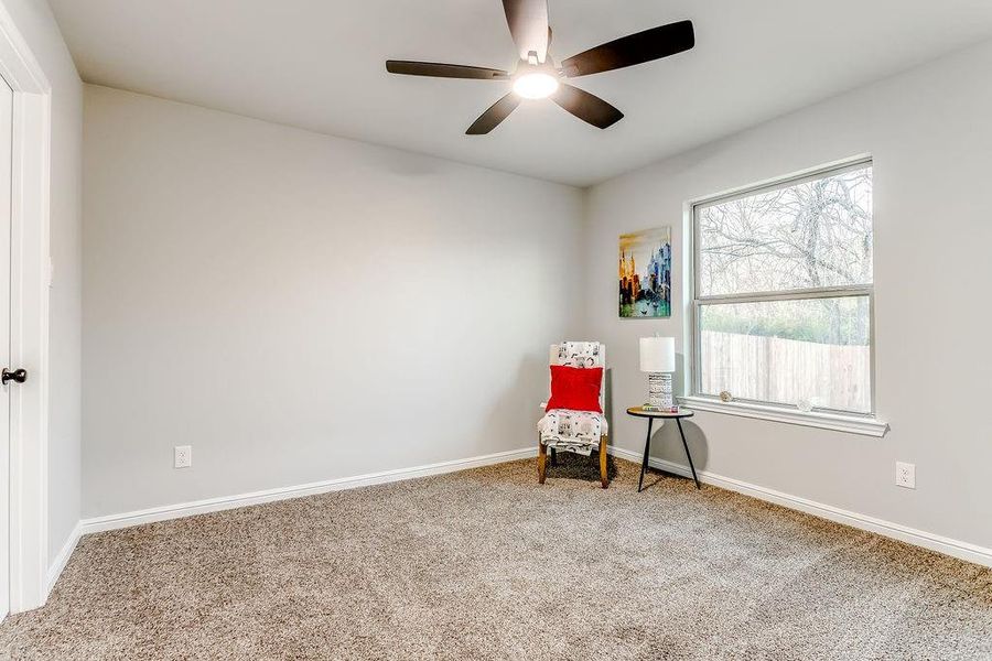 Unfurnished room with ceiling fan and carpet