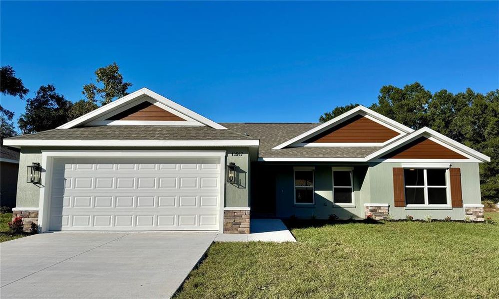 Front exterior of a new home in , Dunnellon, FL, highlighting curb appeal (Image 1).